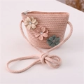 Detailed view of hand-woven straw crossbody bag with decorative floral applique and rhinestones - Jeweled Flower Style / Light Pink