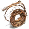 Close-up of natural dried brown rattan wreath with rustic textures for DIY crafts - Tufu Vine