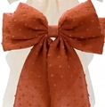 Oversized burnt orange bow hair clip with 3D polka dot texture and elegant streamers - Polka Dot Orange Red