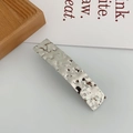 Detailed view of silver rectangular hair clip with hammered metal texture on wood base - Square Heart Silver