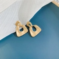 Matte gold geometric hollow trapezoid drop earrings on elegant blue and white fabric - Irregular Trapezoid (Silver Earring Post. Irregular Metal)