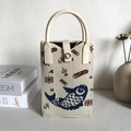 Knitted tote bag in beige with dark blue fish patterns and pink snap button detail - Carp Pattern Beige