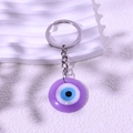 Purple Evil Eye keychain with round resin pendant and silver metal ring for bags - Purple