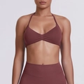Close-up of seamless halter neck sports bra with ruched detail in terracotta red clay color - Brown