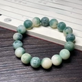 Carved Bodhi seed bracelet with green and white beads on a vintage calligraphy background - Floating Flower Carved Six Characters