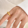 Close-up of a gold ribbed dome ring on finger with modern minimalist texture details - US 6 / Spring Texture Style