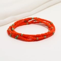 Detailed view of layered orange and turquoise seed bead body chain on white fabric - 80cm / Orange/Turquoise Accents