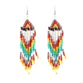 Close-up of handmade bohemian beaded tassel earrings in vibrant multi-color patterns - White Multicolor