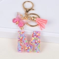 Pink resin letter M keychain with flower sequins, tassel and butterfly pendant decoration - Letter M