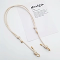 Detail of adjustable beige woven leather bag strap with polished gold metal buckles - Gold Ring Buckle / Off White