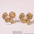 Golden stainless steel bow earrings featuring a white pearl inlay for beach vacations - Bow Artificial Pearl Style (FYD6108)