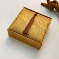 Square golden brocade jewelry gift box featuring woven texture and a silk tassel detail - Bracelet Box