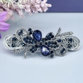 Barrette vintage argentée avec strass bleus étincelants au design floral élégant - Marguerite Orchidée