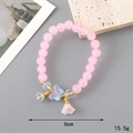 Elegant pink crystal beaded bracelet with gold butterfly charms and floral accents - Pink Glaze Bead + Lily of the Valley (K3333)