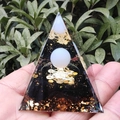 Crystal resin pyramid with black base, gold flakes, and Flower of Life held in hand - Obsidian Flower of Life / Small
