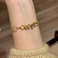 Elegant citrine beaded bracelet with zircon charms on model wrist wearing beige sweater - Yellow Citrine Zirconia Layered Style