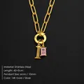 Gold stainless steel necklace featuring letter 'I' pendant and rectangular pink gemstone - Letter I