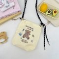 Detail of beige bucket bag with bear embroidery, woven strap, and plush keychain - Little Brown Bear (Beige)
