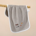 Detail of grey coral fleece towel with duck embroidery and convenient hanging loop - Brown