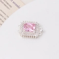Macro detail of silver square clasp featuring a large pink gemstone and pavé zircon accents - Silver-Pink