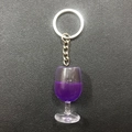 Creative resin wine glass keychain with purple liquid on black leather background - Purple