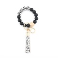Close-up of silicone bead keychain featuring leopard print beads and tassel details - 14 White Leopard