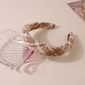 Detailed texture of plaid wool headband with beige and brown patterns and handmade label - Beige Brown Yellow Plaid