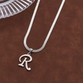 Polished silver snake chain necklace with capital letter R pendant on brown velvet - Letter R