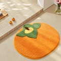 Round orange persimmon shaped absorbent plush bathroom mat with green leaf detail - Good Things Persimmon