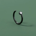 Black stainless steel U-shaped nose ring with a clear zircon stone on green background - Open Ring with Zirconia / Black