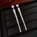Elegant gold-tone drop earrings with graduated white pearls on black leather display - Pearl Long Drop (38#)