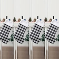 Set of four black and white plaid Christmas stockings with plush white cuffs hanging - Set of 4 / Set of 4 Black and White Plaid