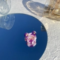 Détail d'une pince à cheveux ours marbrée violette avec accents dorés sur miroir bleu - Tête d'Ours Violet Foncé