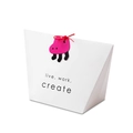 White gift bag featuring live work create text and pink elephant tag with red string - White