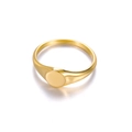Detailed view of a minimalist golden signet ring with a round flat top and smooth finish - Round Flat Signet