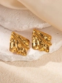 Detail shot of golden crumpled metal stud earrings on white stone and silk fabric - Oil Pressed Texture Earrings