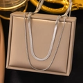 Minimalist double-layered silver snake bone chain necklace displayed on a jewelry stand - AH490 Blade + Round Snake / Steel