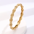 Macro detail of gold plated geometric bangle showing intricate embossed floral textures - Gold - Relief Carved