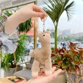 Cute light brown alpaca plush keychain with golden metal clip held in hand - Gold Clasp / Brown