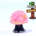 Macro detail of pink crystal gemstone tree with resin trunk on a stone base - Rose Quartz with Gold Foil