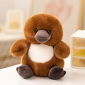 Cute brown plush platypus toy with white chest detail sitting on a white table - Platypus (22cm)