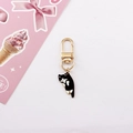 Detail of cute black and white enamel cat keychain with golden metal finish and ring - Grumpy Black White Cat
