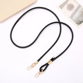 Detail of adjustable black PU leather crossbody strap with gold metal buckles for bags - Black