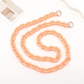 Macro view of peach acrylic crossbody chain strap with silver metal spring buckles - Crossbody / Orange (K081)