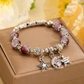 Purple beaded bracelet with silver moon and star charms on a gold jewelry box - Purple Stone Star Moon Engraved Bracelet (9956)
