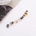 Snake shaped gold metal ear cuff with hanging colorful natural stone beads on white background - Short Style / Black and White Short