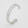 Detailed view of silver C-shaped open bangle with hollow multi-layer skeleton design - Silver CK526-SR (Hollow Lines)