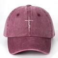 Close-up of embroidered white cross and faith script on washed burgundy cotton baseball cap - Burgundy