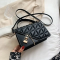 Chic black quilted crossbody bag with gold chain lock and geometric triangular stitching - Black