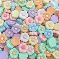Macro shot of colorful mini resin flower beads for DIY nail art and hair accessories - Swirl Flower
